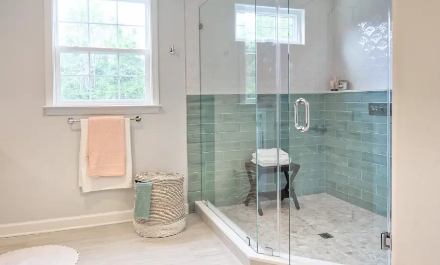 Modern bathroom with spacious glass shower and towels