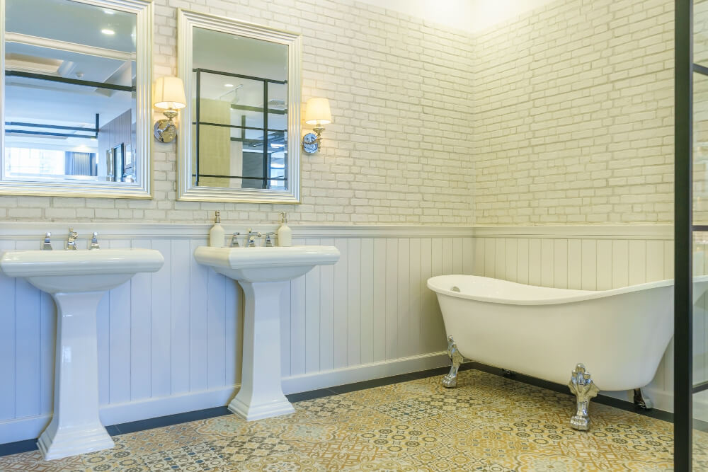 Elegant bathroom with tub and vintage sinks